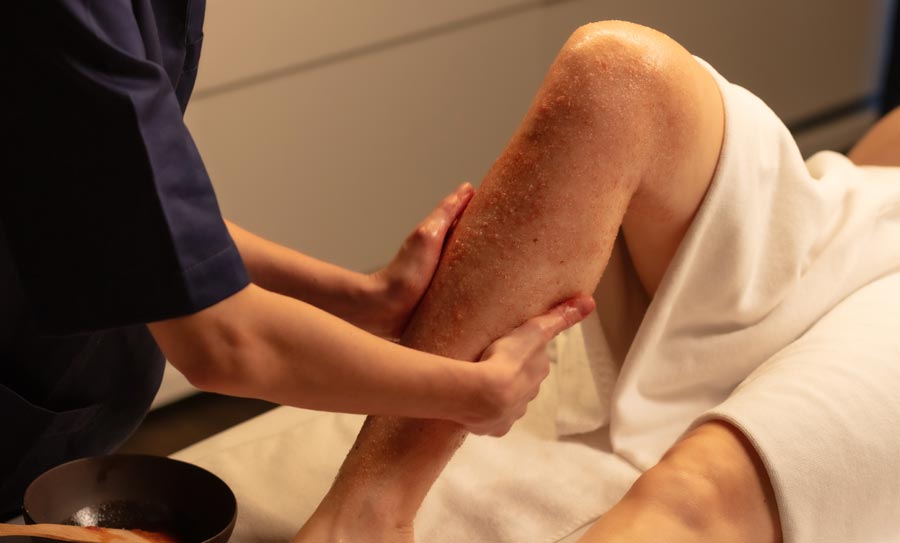 Beauty therapist giving a leg massage